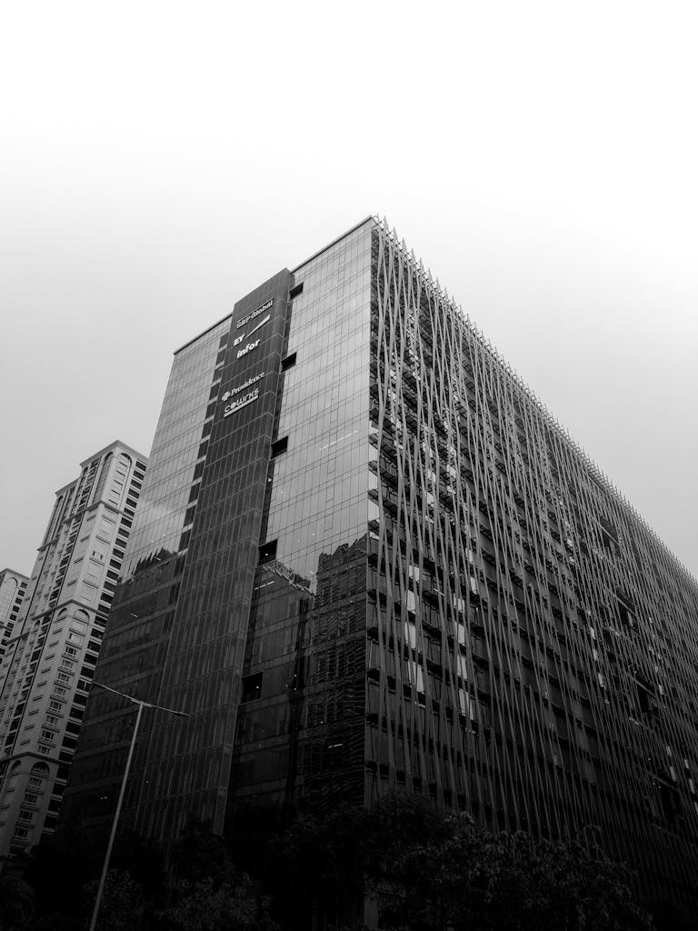 Tall modern glass skyscraper in India, showcasing contemporary architecture.